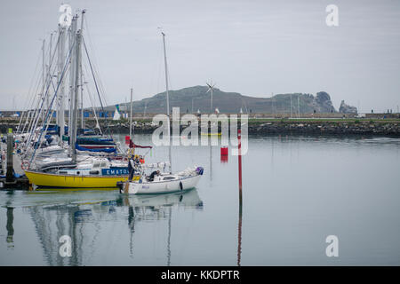 Man sailing in his boat out of the howth`s harbor into the open Irish sea, Howth Peninsula, Dublin, Ireland Stock Photo